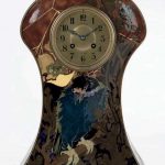 A GLAZED POTTERY MANTLE CLOCK