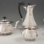 A GEORGE V ART NOUVEAU SILVER FOUR-PIECE TEA SERVICE