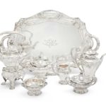 A FINE GORHAM ART NOUVEAU MARTELÉ SILVER SIX-PIECE TEA AND COFFEE SERVICE TOGETHER WITH MATCHING TWO-HANDLED TRAY