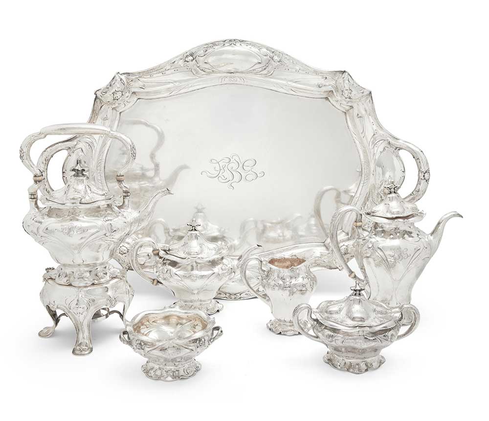 A FINE GORHAM ART NOUVEAU MARTELÉ SILVER SIX-PIECE TEA AND COFFEE SERVICE TOGETHER WITH MATCHING TWO-HANDLED TRAY