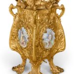 An Art Nouveau style cast-brass and porcelain mounted four-handled jardinière Paris, late 19th century