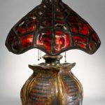 A glass, glazed stoneware and bronze table lamp